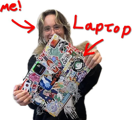 Armand holding up the sticker-covered laptop lid.
